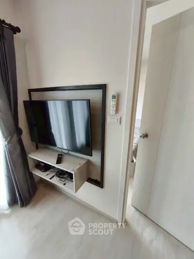 Modern living room with wall-mounted TV and sleek decor