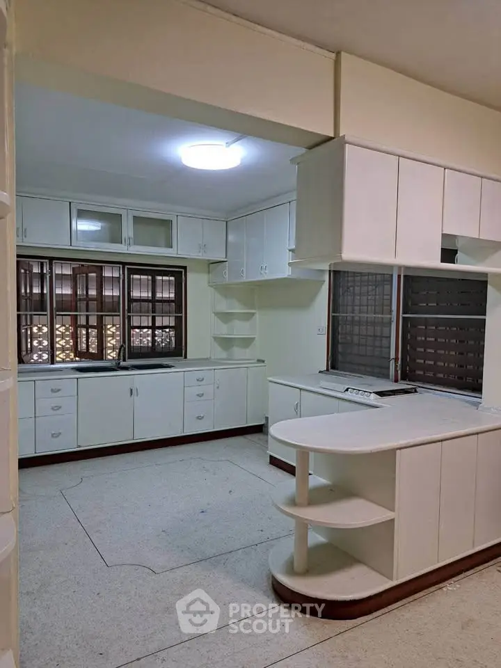 Spacious kitchen with ample storage and open layout design, perfect for culinary enthusiasts.