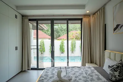 Luxurious bedroom with pool view and elegant decor