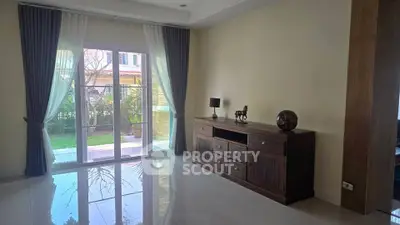 Spacious living room with elegant decor and garden view, perfect for relaxation and entertaining.