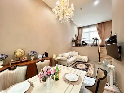 Luxurious split-level living room with elegant chandelier and cozy seating area