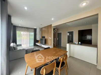 Spacious open-plan living and dining area with modern furnishings and natural light.