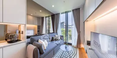 Modern living room with large windows and stylish decor in a luxury apartment.
