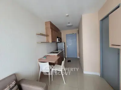 Modern compact kitchen with dining area in cozy apartment