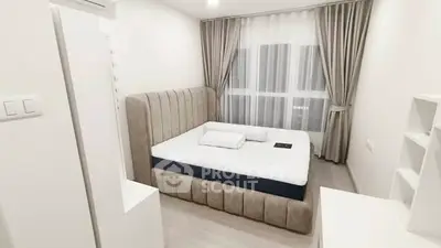 Modern bedroom with plush bed and elegant curtains in a bright, minimalist design.