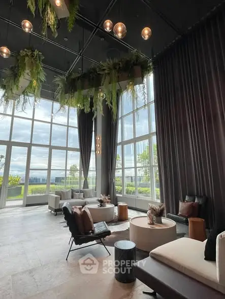 Luxurious living room with high ceilings and panoramic windows offering stunning views.