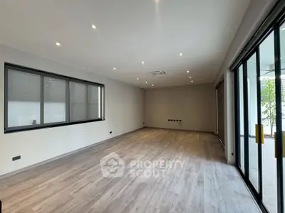 Spacious modern living room with large windows and sleek flooring
