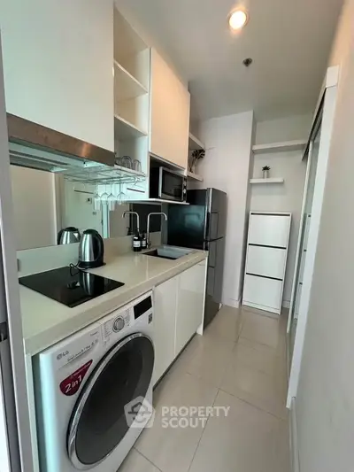 Modern compact kitchen with appliances and sleek cabinetry