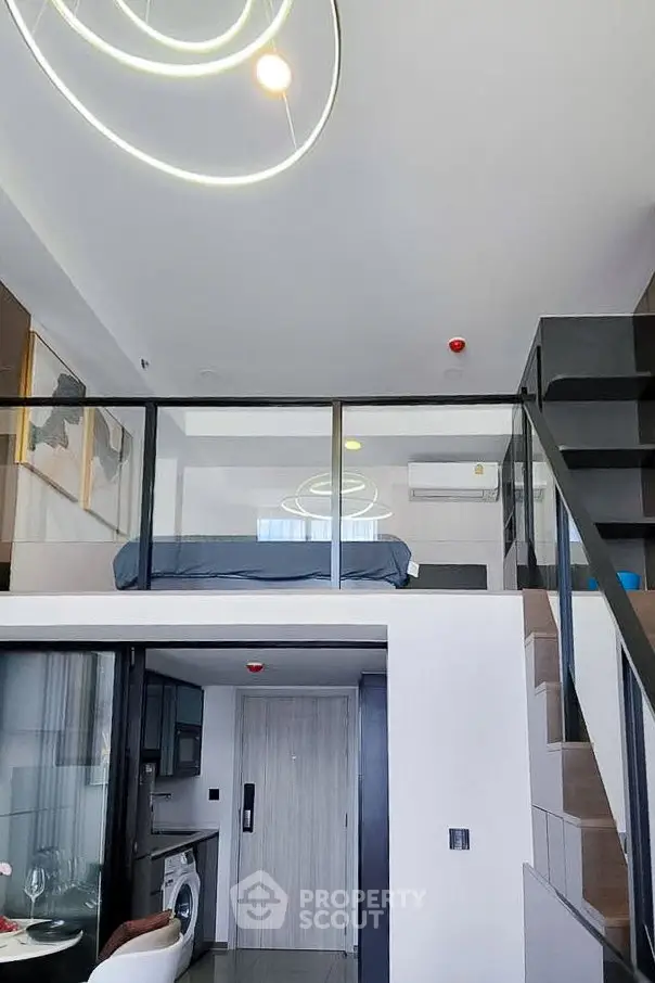 Modern loft apartment with mezzanine bedroom and stylish open-plan living area.