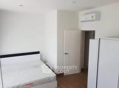 Modern minimalist bedroom with air conditioning and wooden flooring