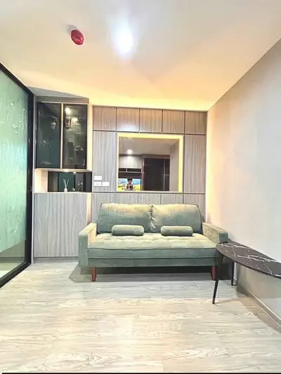 Modern living room with stylish sofa and sleek cabinetry in a contemporary apartment.