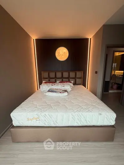 Modern bedroom with stylish lighting and comfortable bed in a contemporary apartment.
