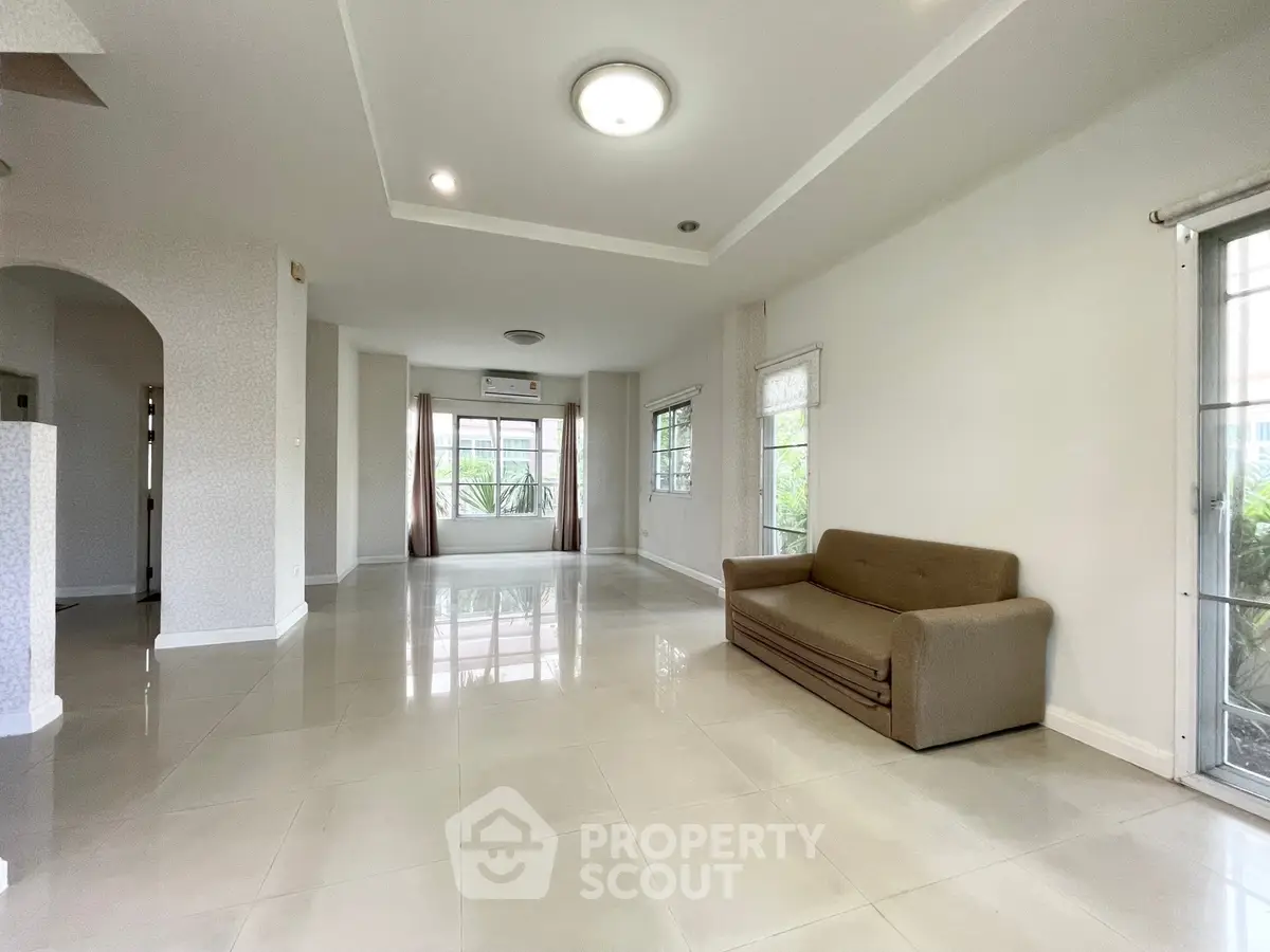 Spacious living room with modern design and large windows for natural light