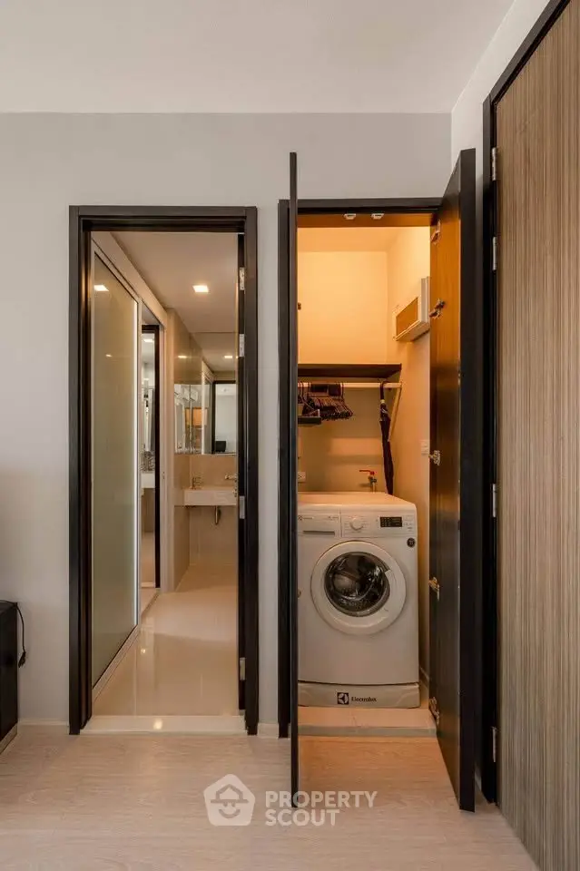 Modern apartment with in-unit washing machine and sleek bathroom design.