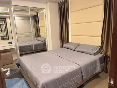 Modern bedroom with mirrored closet and elegant decor in a stylish apartment.