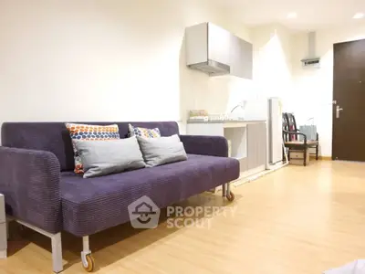 Modern living room with stylish sofa and compact kitchen area