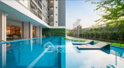 Luxurious apartment complex with stunning outdoor pool and lush greenery.