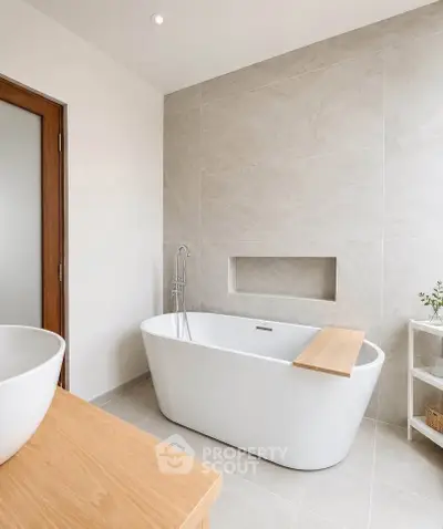 Elegant bathroom with modern freestanding bathtub and minimalist design.