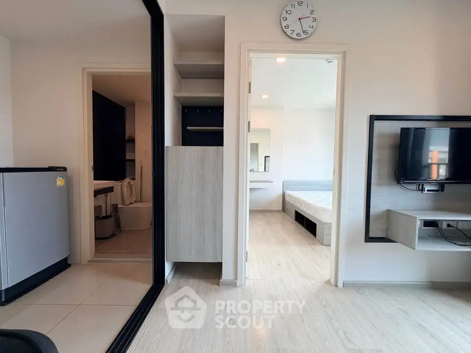 Modern apartment interior with open layout, featuring a cozy living area, bedroom, and bathroom.