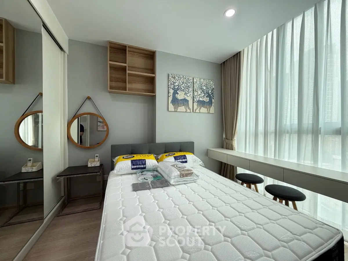 Modern bedroom with stylish decor and large window for natural light