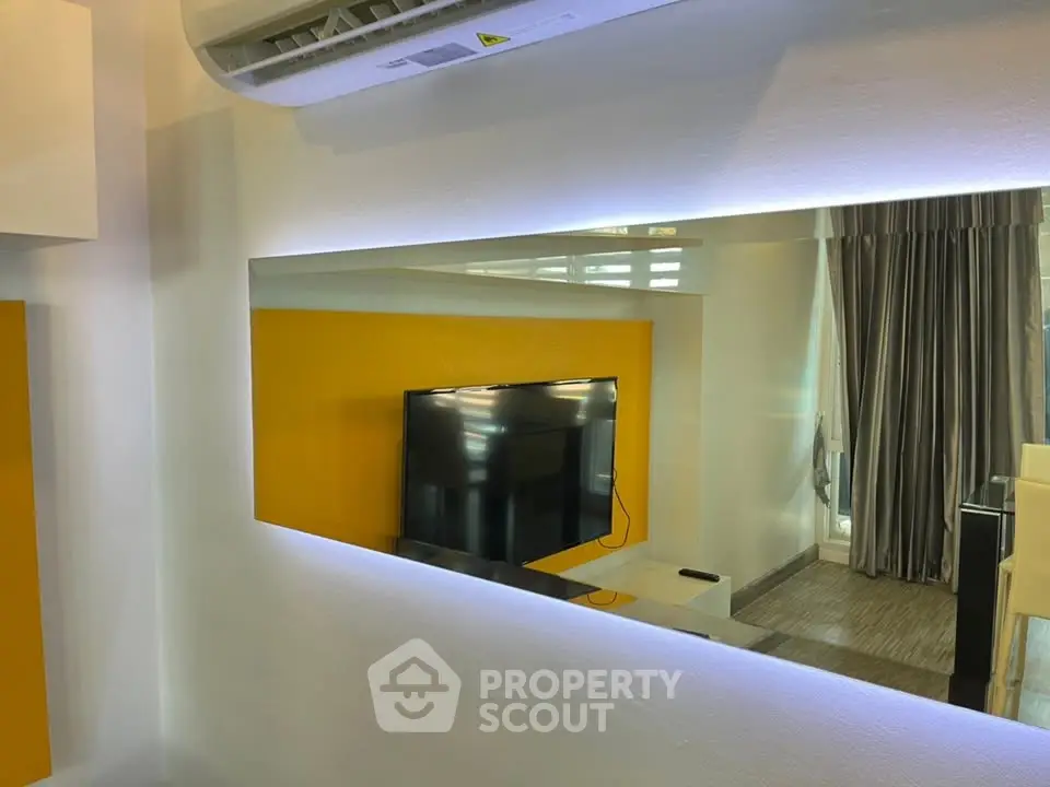 Modern living room with wall-mounted TV and stylish decor