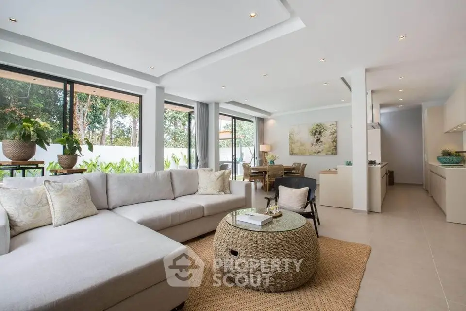 Spacious modern living room with large windows and stylish decor
