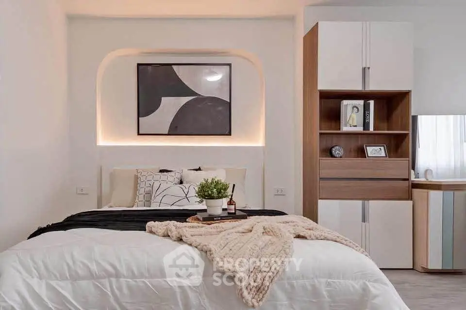 Modern bedroom with stylish decor and cozy ambiance, featuring elegant lighting and contemporary furniture.