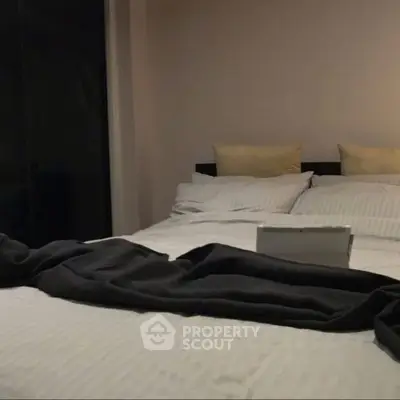 Cozy bedroom with stylish bedding and soft lighting, perfect for relaxation and comfort.