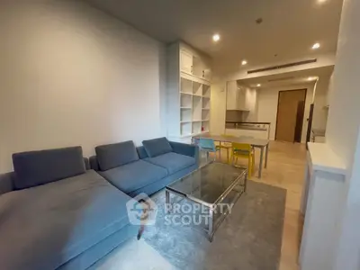 Modern living room with stylish furniture and open kitchen layout in a cozy apartment.