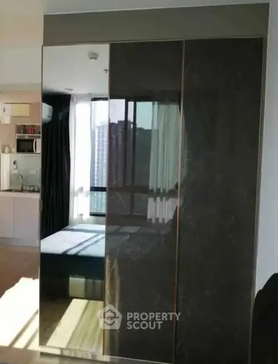 Modern bedroom with sleek wardrobe and city view