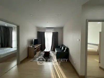 Spacious living room with natural light and modern furnishings