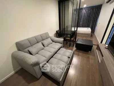 Modern studio apartment with cozy living area and stylish furnishings.