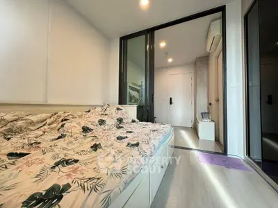 Modern bedroom with floral bedding and sleek design in a stylish apartment.