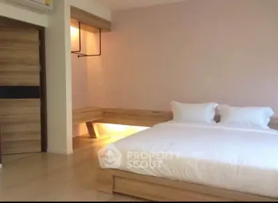 Modern minimalist bedroom with wooden accents and ambient lighting