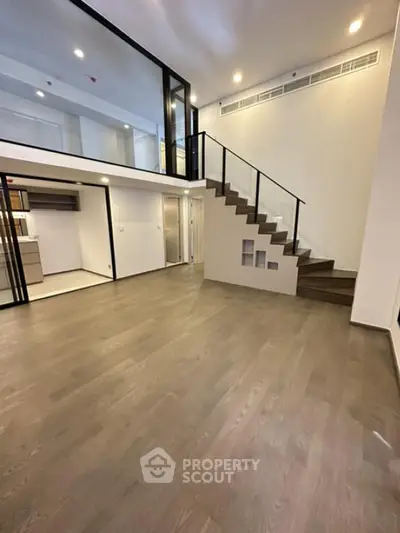 Modern duplex apartment with sleek staircase and open layout