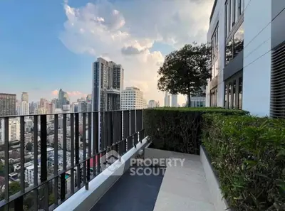 Stunning cityscape view from a modern high-rise balcony with lush greenery.