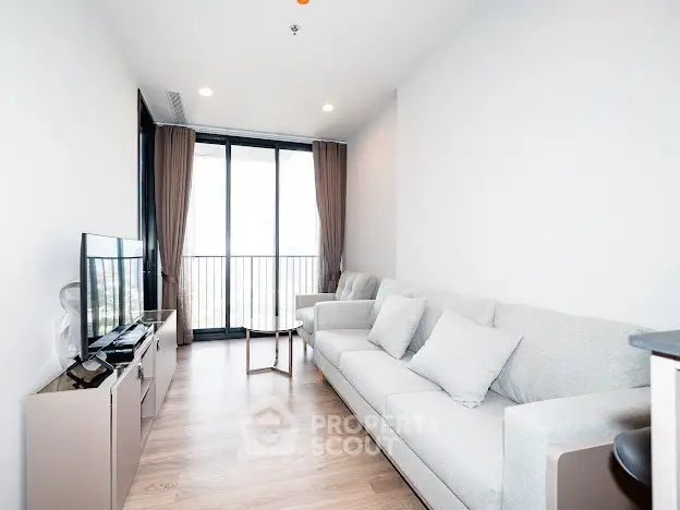 Bright modern living room with large windows and stylish furniture.