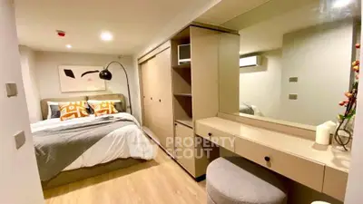 Modern bedroom with stylish decor and ample storage in a cozy apartment.