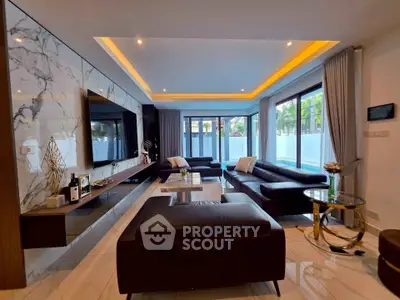 Luxurious modern living room with elegant marble accents and spacious seating area.