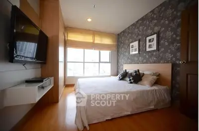 Modern bedroom with stylish decor and large window for natural light