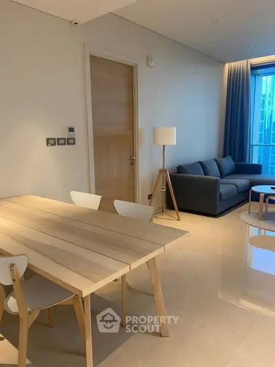 Modern living room with sleek furniture and natural light, perfect for urban living.