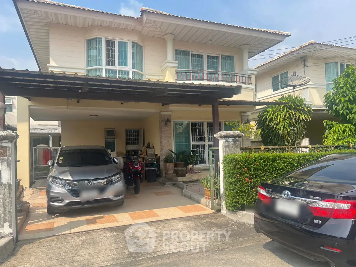 Charming two-story house with spacious driveway and lush greenery in a serene neighborhood.