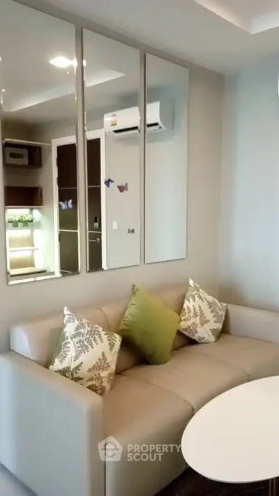 Modern living room with stylish sofa and decorative mirrors, perfect for cozy relaxation.