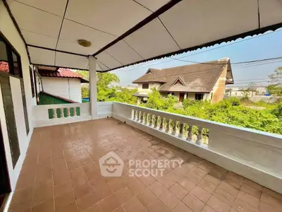 Spacious balcony with scenic view of suburban neighborhood and lush greenery.