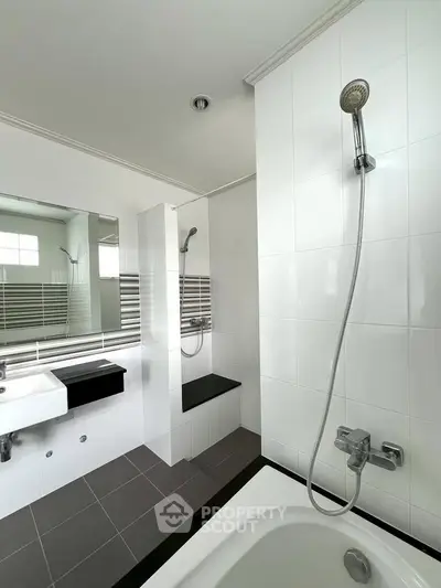 Modern bathroom with sleek fixtures and a spacious shower area.
