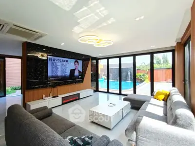 Luxurious living room with pool view and modern decor