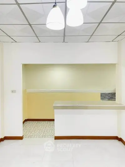 Modern kitchen with open layout and stylish lighting in a contemporary apartment.