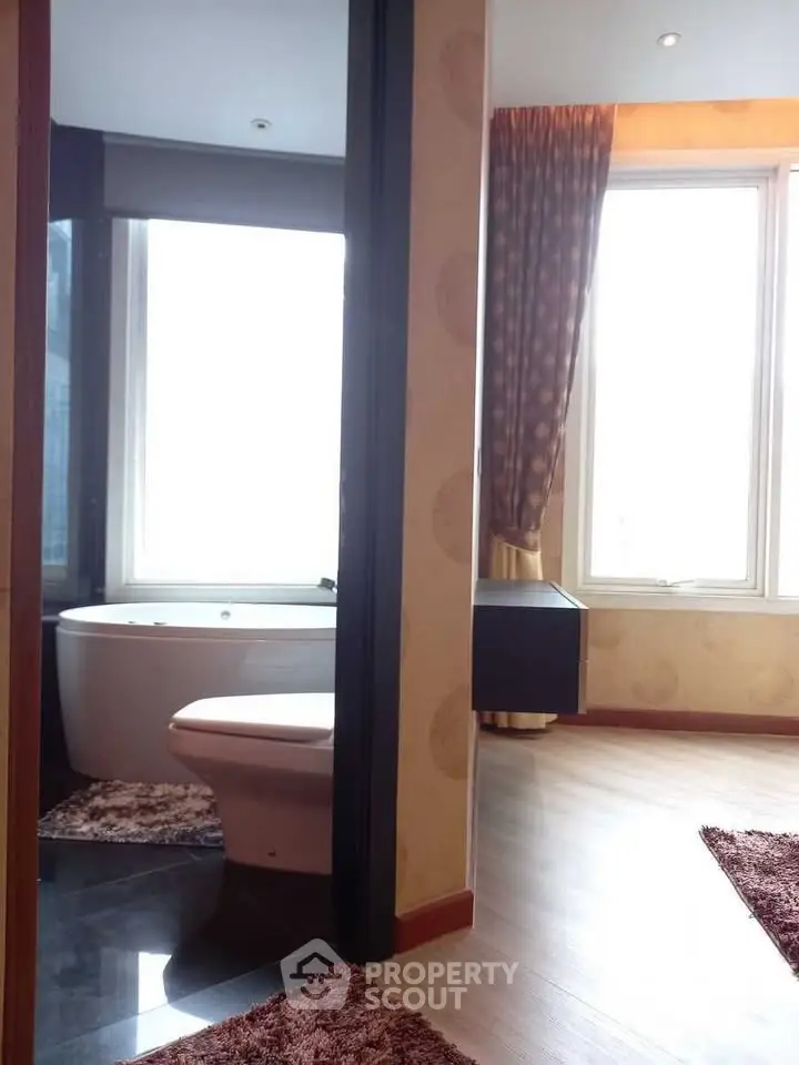 Luxurious bathroom with modern bathtub and large windows in a stylish apartment.