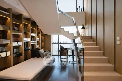 Luxurious modern living room with elegant staircase and built-in bookshelves, perfect for stylish urban living.