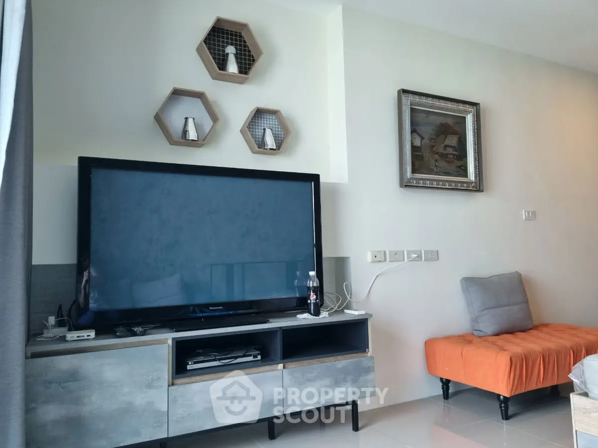 Modern living room with stylish TV setup and cozy seating area